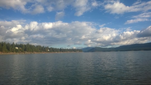 Calm lake and puffy clouds.